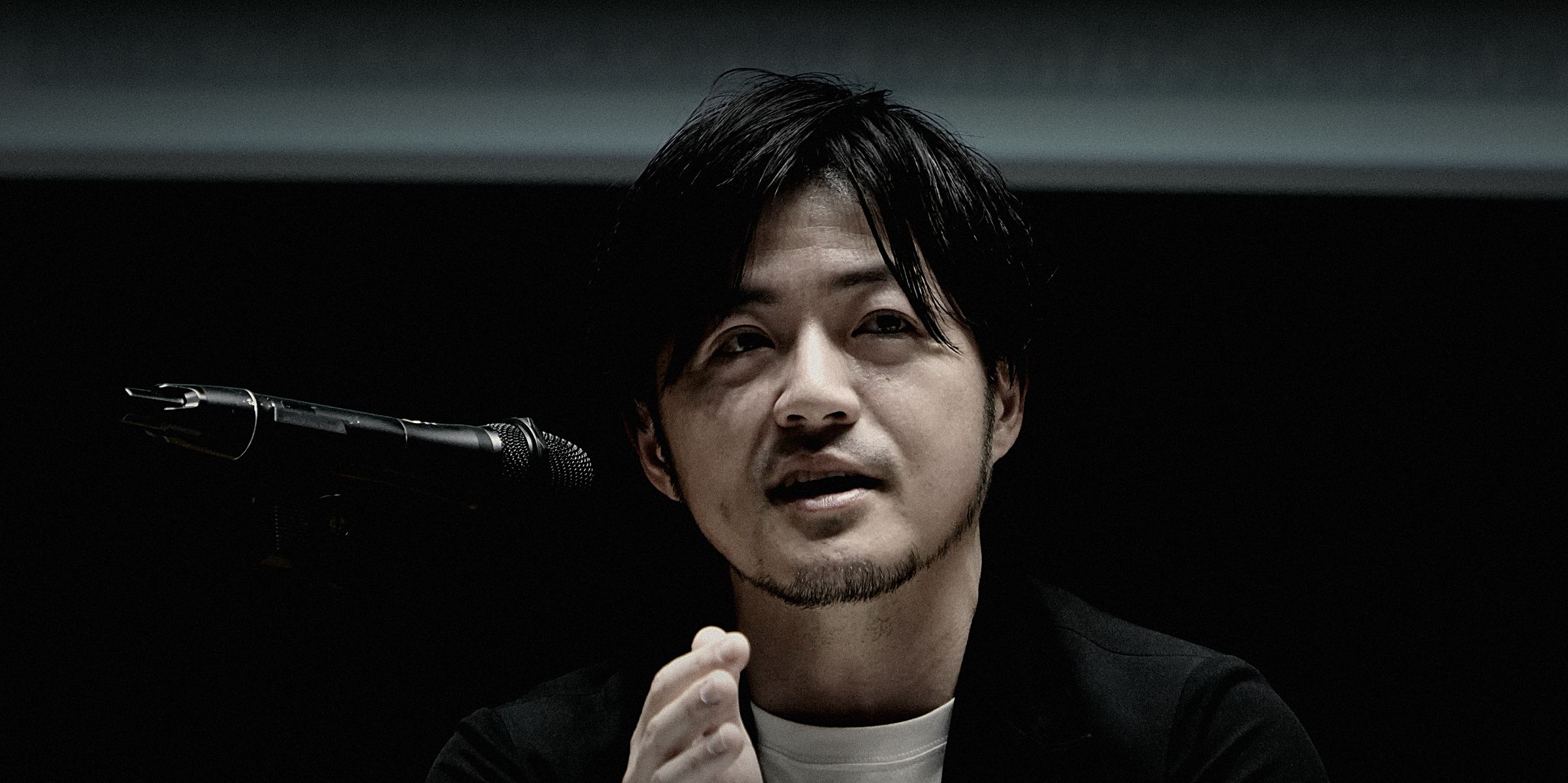 登壇し、聴衆に語りかける古田大輔